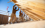 Workers lifting a wall